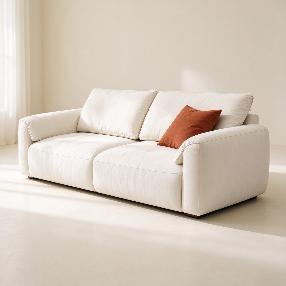 Field sofa straight-on with a rust cushion