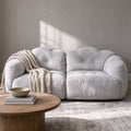 Russet modular sofa in light grey with a knit throw, studio view