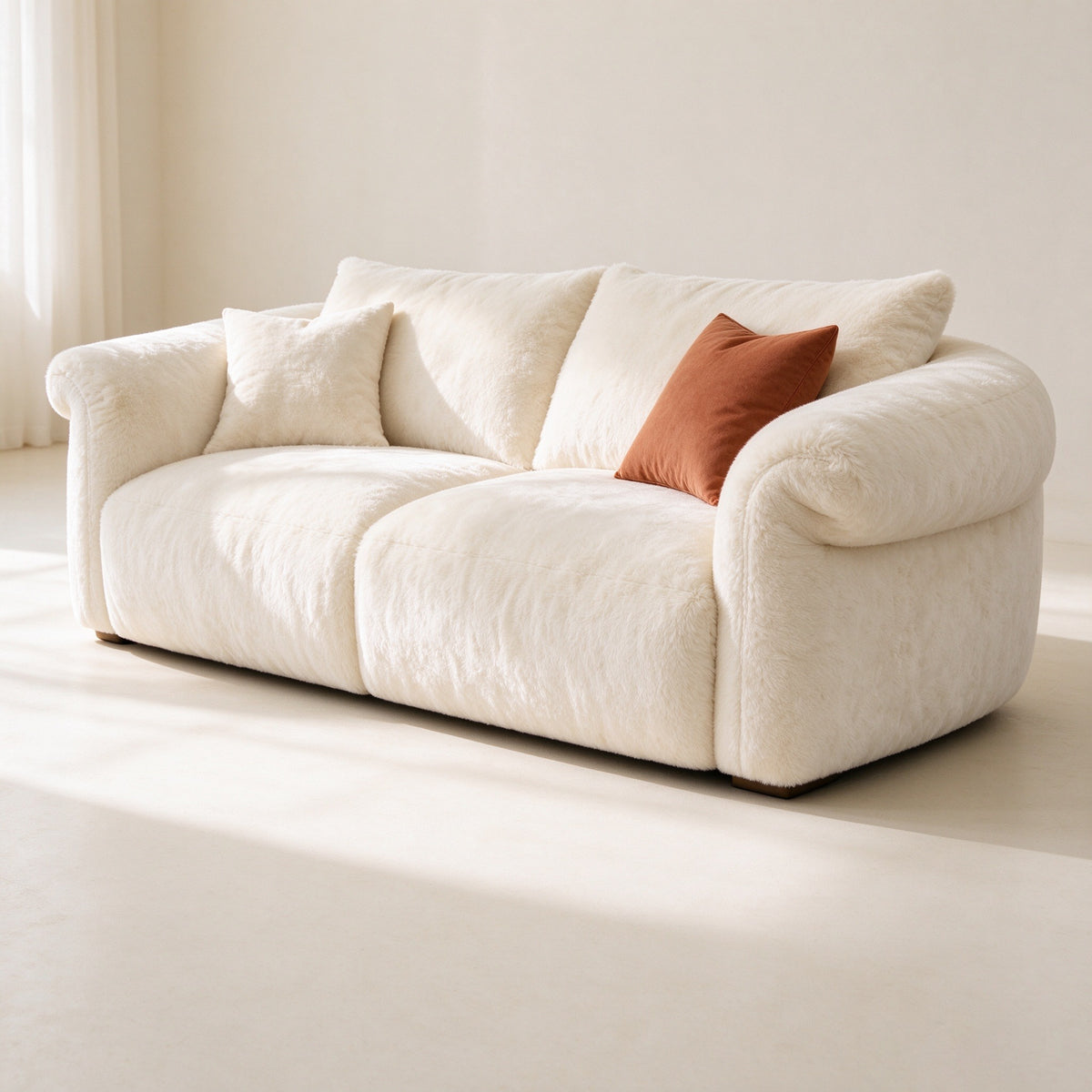 Union sofa in cream ivory, three-quarter view with a rust cushion